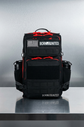 Black and red backpack with 'Born United' branding on a metallic surface.