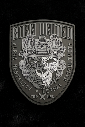 The Alpha Mentality PVC Patch by Born United Private Label features a dark shield with a snarling animal skull in night vision goggles, boldly displaying "Alpha Mentality" and "Lethal Masculinity," encircled by "Born United" and "TRD MRK.