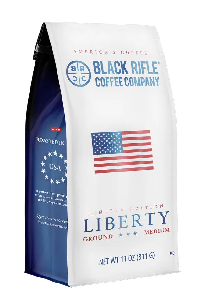 A limited-edition 11 oz (311 g) bag of Black Rifle Coffee’s Liberty Roast- Ground, a medium roast featuring an American flag design on a white bag with navy blue sides.