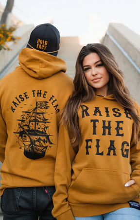 relentless betrayal - unisex raise the flag premium toast hoodie on models